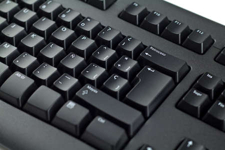 Spanish PC keyboard of black color closeup view