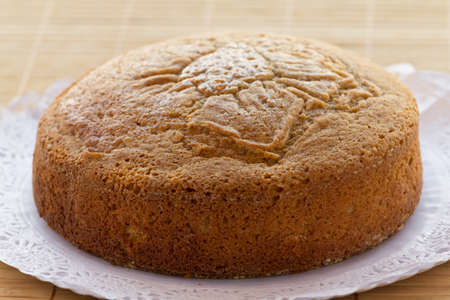 Homemade sponge cake over paper doily