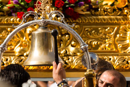 MALAGA, SPAIN - JULY 16: Unidentified local worshipper hit the bell to raise the throne during the...