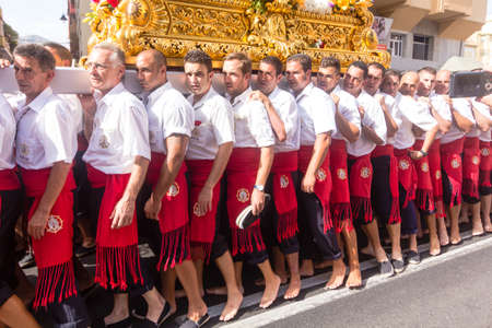 MALAGA, SPAIN - JULY 16: Unidentified barefoot worshippers carry a religious image during the 