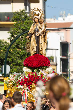 MALAGA, SPAIN - JULY 16: Religious image of Virgen del Carmen is lifted through the city streets during the procession on July 16, 2013 in Malaga, Spain. Virgen del Carmen is the patron saint and protector of fishermen and sailorsのeditorial素材