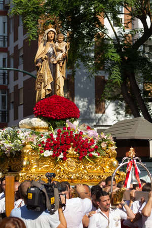 MALAGA, SPAIN - JULY 16: Religious image of Virgen del Carmen is lifted through the city streets during the procession on July 16, 2013 in Malaga, Spain. Virgen del Carmen is the patron saint and protector of fishermen and sailorsのeditorial素材
