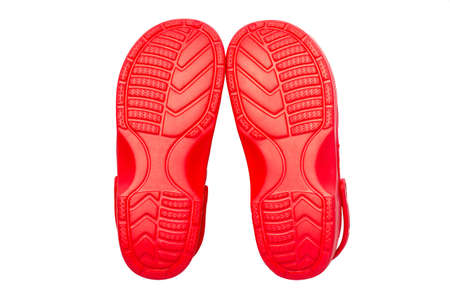 Red rubber shoes on a white backgroundの写真素材