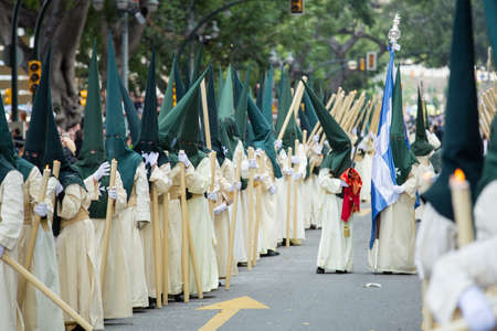 Nazarenes holding their candles on palm sunday (easter week). Holy Week in Spain.