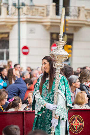 MALAGA, SPAIN - MARCH 20: Girl with silver staff participating in the procession of Palm Sunday (Pollinica) on March 20, 2016 in Malaga, Spain.のeditorial素材
