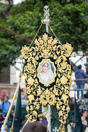 MALAGA, SPAIN - MARCH 20: Nazarenes holding a banner of the Virgin Mary in the procession of Palm Sunday (Pollinica) on March 20, 2016 in Malaga, Spain.のeditorial素材