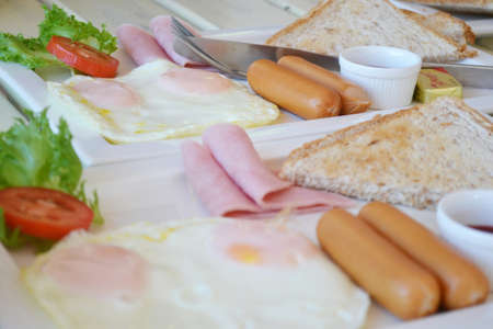 breakfast useful Fried egg, ham, sausage, Bread & Butter very delicious.の写真素材