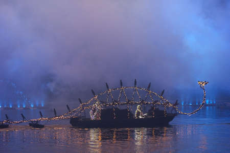 Castle of Versailles, France - June 24 2011 / The Venetian Festivities on the Grand Canal : Dragon boat enlightened by the fireworksのeditorial素材
