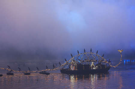 Castle of Versailles, France - June 24 2011 / The Venetian Festivities on the Grand Canal : Dragon boat enlightened by the fireworksのeditorial素材