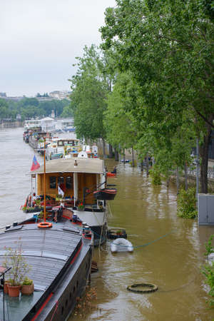 PARIS, FRANCE - JUNE 4: Paris flood with high water on June 4, 2016 in Paris, France. Barges and Quay in the floodsのeditorial素材