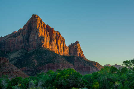 Red Sunset in Zion National Park green and orange colours with blue skyの写真素材