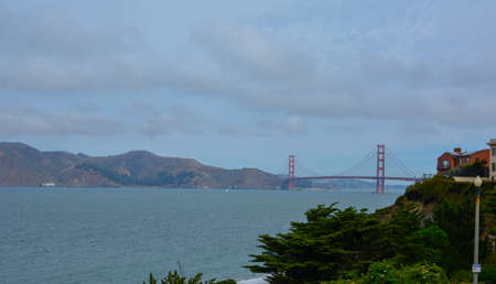 Golden gate bridge in cloudy summer timeの写真素材