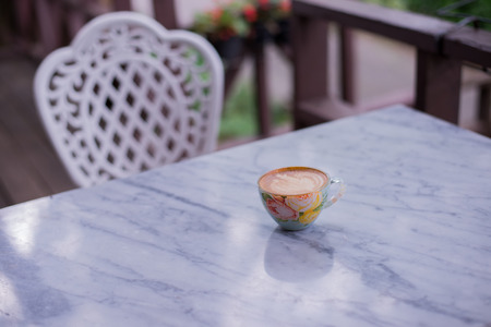 Cup of hot drink with coffee on table.の写真素材