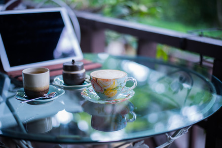 Cup of hot drink with coffee on table.の写真素材