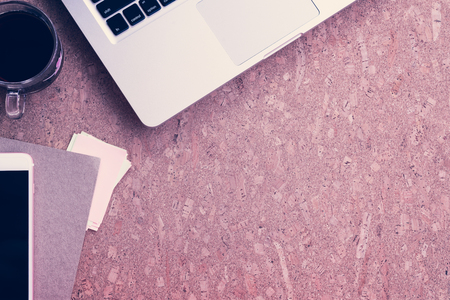 Working desk table concept. Office desk table with laptop, blank paper notebook,cup of coffee and smartphone . Top view with copy space.の写真素材