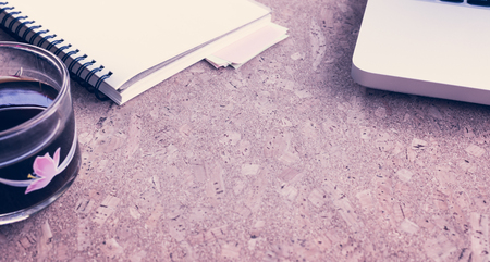 Working desk table concept. Office desk table with laptop, blank paper notebook,cup of coffee and smartphone . Top view with copy space.の写真素材