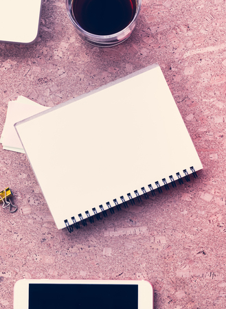 Working desk table concept. Office desk table with laptop, blank paper notebook,cup of coffee and smartphone . Top view with copy space.の写真素材