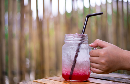 Strawberry Soda holding in the hand with bokeh background.の写真素材