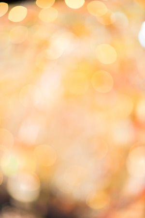 Gold bokeh abstract  glitter light on background. Golden christmas light shine bright holiday magic decoration.の写真素材