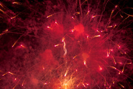 Fireworks. Stars and shiny fireworks on red background.の写真素材