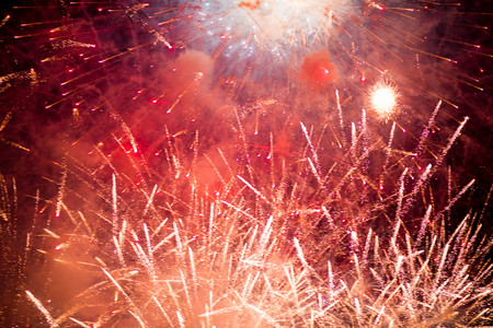Fireworks. Stars and shiny fireworks on red background.の写真素材