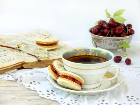 cup of espresso coffee and French macaroons dessert stuffed with cornel on light wooden backgroundの写真素材