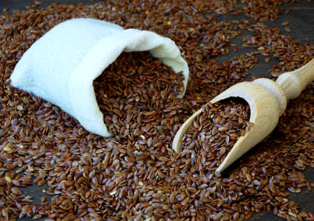 flax seeds in a sack and shovel. selective focusの写真素材