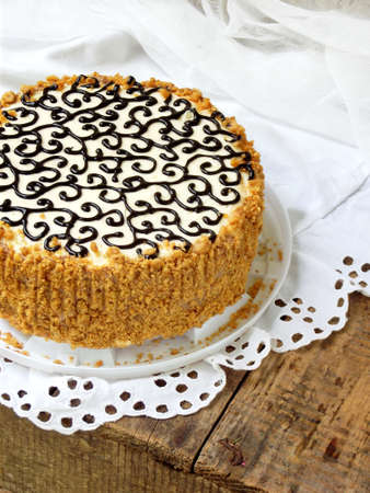 homemade cake with nut meringue butter cream and decorated with swirls of dark chocolate. Kyiv cake...