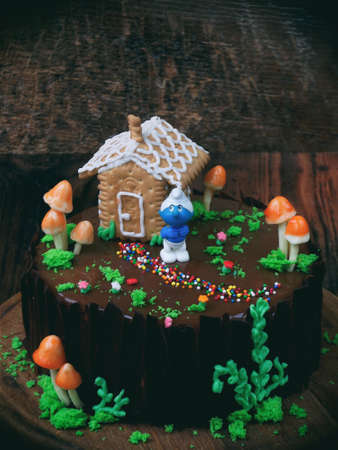 Cake "Fairy Tale" with house of cookies on dark backgroundの写真素材