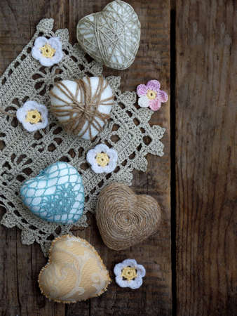 Valentines Day concept. Composition of colourful handmade hearts on wooden background. Needlework. Copy space. Selective focusの写真素材