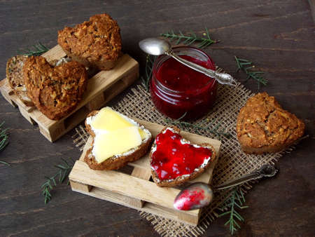 Valentine's Day breakfast. Composition of wholegrain muffins in the form of heart with butter,...