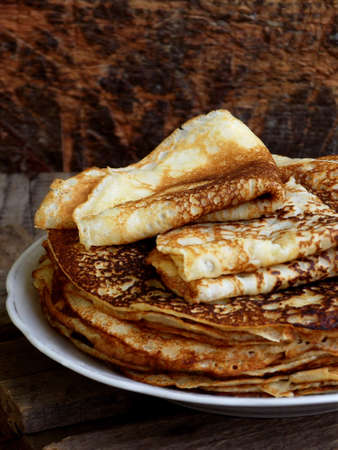 Fried crepes on the plate. Russian pancakes. View from side. Selective focus