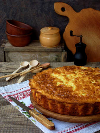 Savory cabbage pie with cheese and eggs on a wooden background. Homemade quiche. Selective focusの写真素材