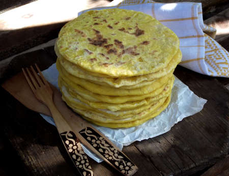 stack pies in the pan. Pies with cheese and herbs.