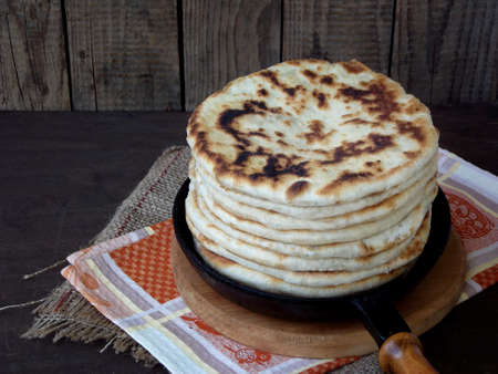 stack pies in the pan. Pies with cheese and herbs.