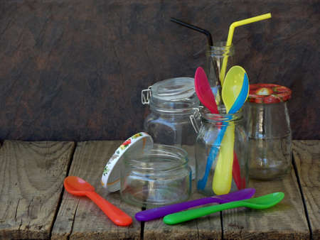 Different empty jar and bottles on wooden backgroundの写真素材