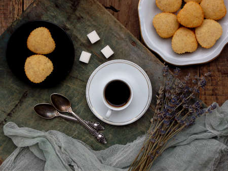The composition of the gluten-free rice-banana muffin, a cup of coffee and a bouquet of lavender....