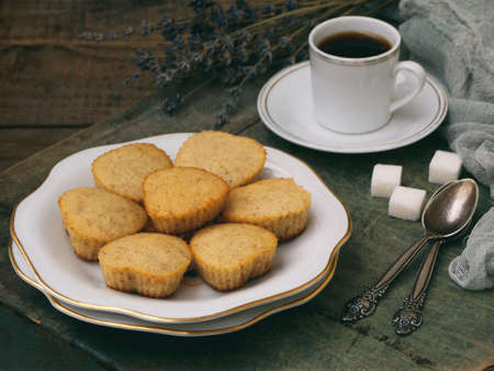 The composition of the gluten-free rice-banana muffin, a cup of coffee and a bouquet of lavender. Romantic breakfast. Vintage photo.の写真素材