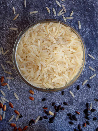 basmati rice in bowl on grey background. Top view. Copy spaceの写真素材