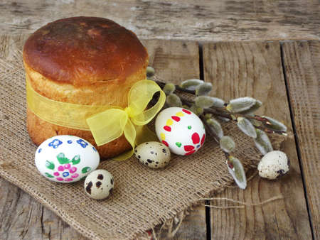 Easter composition of sweet bread, paska and eggs on wooden background. Orthodox kulich. Holidays...