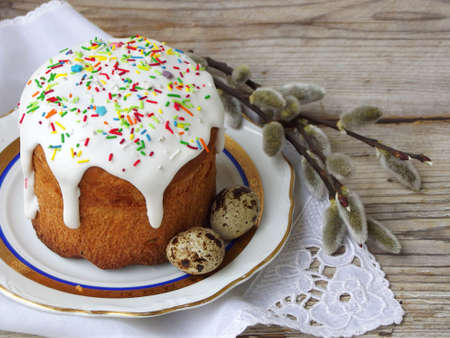Easter composition of sweet bread, paska and eggs on wooden background. Orthodox kulich. Holidays...