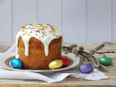 Easter composition of sweet bread, paska and eggs on wooden background. Orthodox kulich. Holidays...