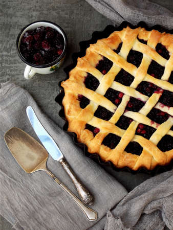 Traditional berries yeast pie tart on rustic wooden background. Homemade sweet cake. Baked pastry food. Top view. Space for text.の写真素材