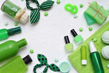 Lime mint composition of beauty threatment products in green colors on a white concrete background: shampoo, soap, bath salt, towel, oil. Various bath accessories. Items for the spaの写真素材