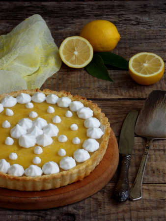 Lemon tart pie with meringue cream. Homemade cake on wooden backgroundの写真素材