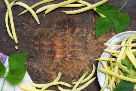Fresh bio organic asparagus beans on a wooden background. Healthy food. Copy space border. Mockup for menu or recipe.の写真素材