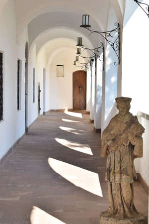 Aisle of a castle with arches in white tonesの写真素材