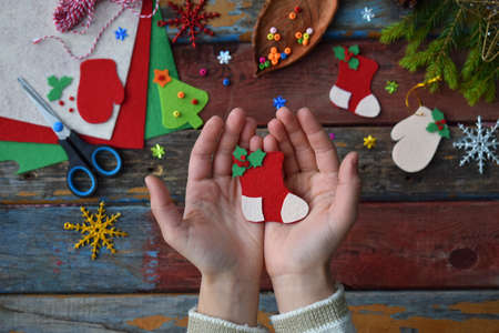 Making of handmade christmas toys from felt with your own hands. Children's DIY concept. Making xmas tree decoration or greeting cardの写真素材