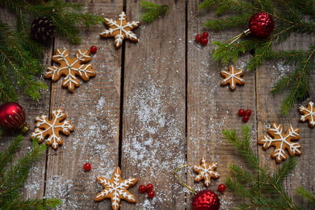 Christmas composition with gingerbread cookies, festive decoration, candle and fir tree branch. Holiday, New Year, Xmas concept. Vintage style. Flat lay, top view, with copy space.の写真素材