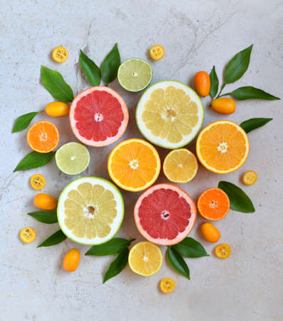Set of citrus on light background: orange, mandarin, lemon, grapefruit, lime, kumquat, tangerine. Fresh organic juicy fruits. Source of vitamin C. Healthy food concept Copy spaceの写真素材